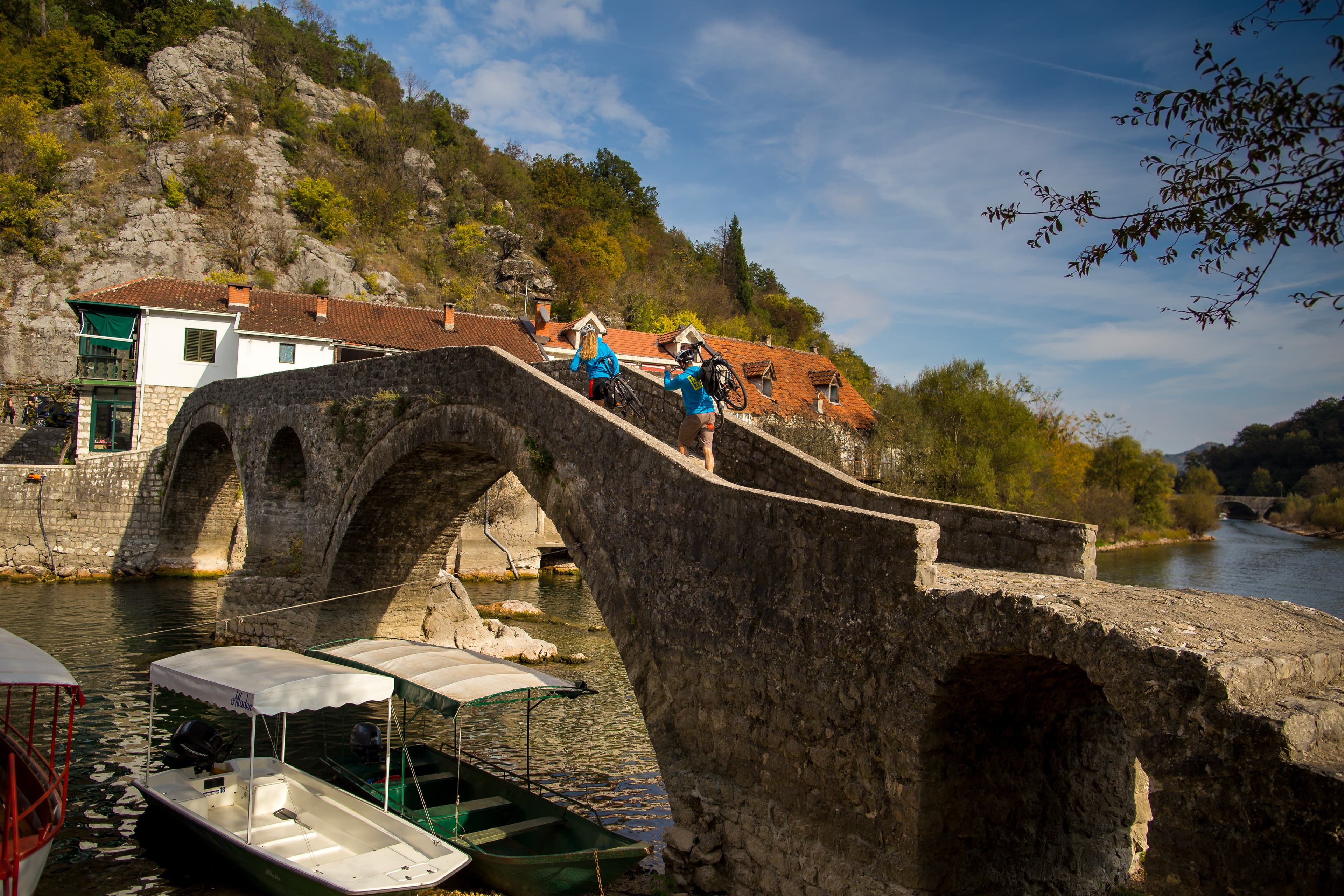 Cyclists on a quiet coastal road in Montenegro above the Adriatic